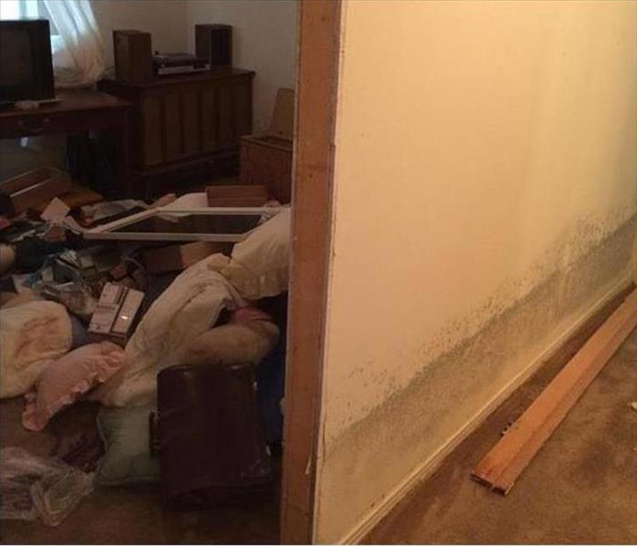 stacked contents, shown water line on wall after flooding