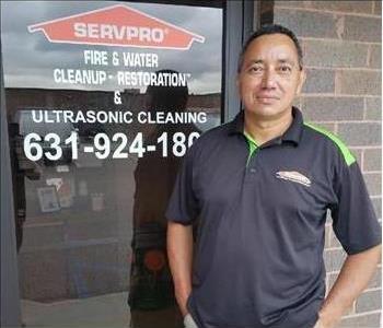 male, posing in black shirt in front of servpro entrance