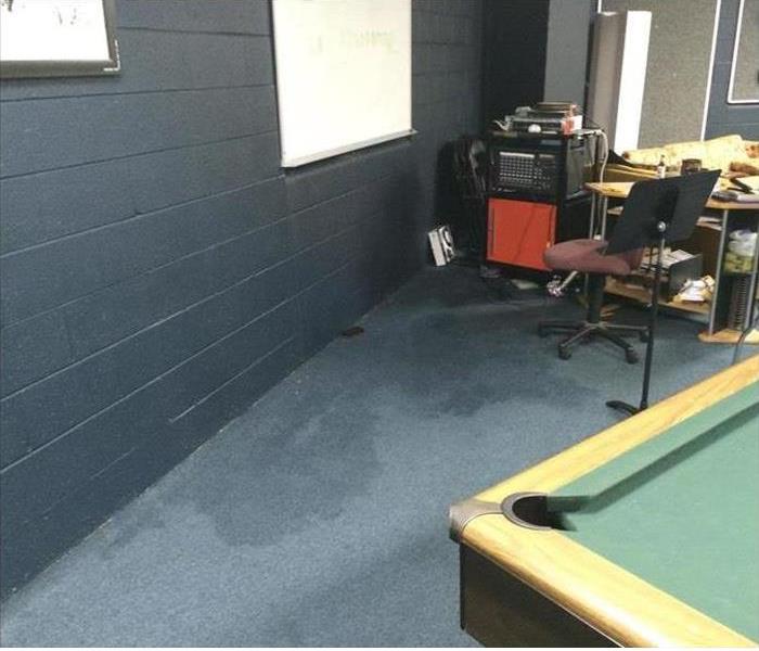 water stain, flue carpet, block wall and pool table